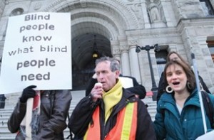 Photo of Graeme and Elizabeth speaking at the rally